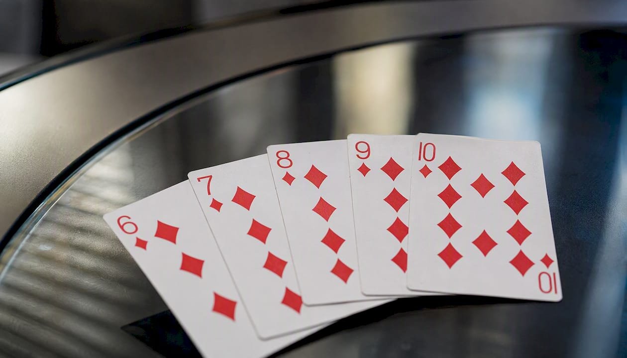 Straight Flush cards fan on poker table